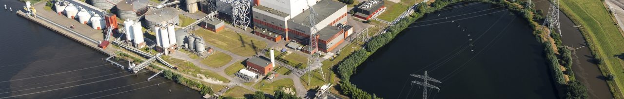 19 July 2016, Geertruidenberg, Holland. Aerial view of the AMERCENTRALE, a coal and biomass fired Essent powerplant. It's located at the river Amer. In the back the town of GEERTRUIDENBERG. 